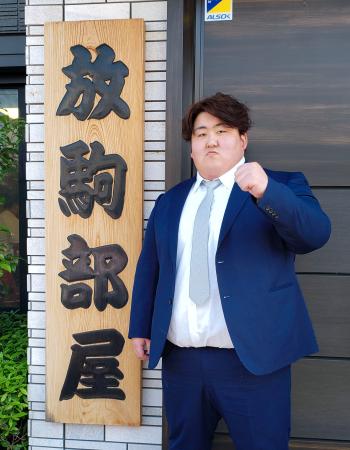 放駒部屋の前でポーズをとる白神嶺治=20日、東京都足立区