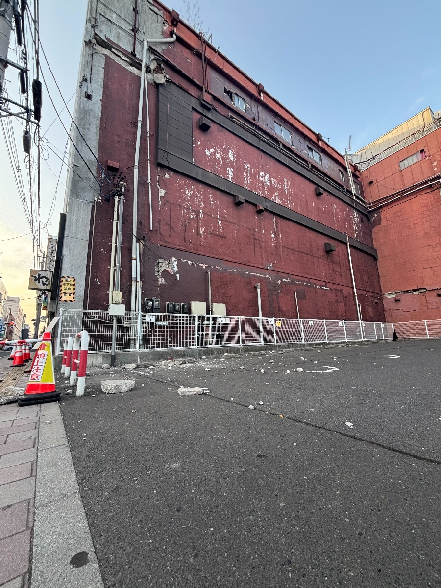 八戸市中心街の長横町ではビルの壁が一部崩れた＝２０日午後５時半ごろ