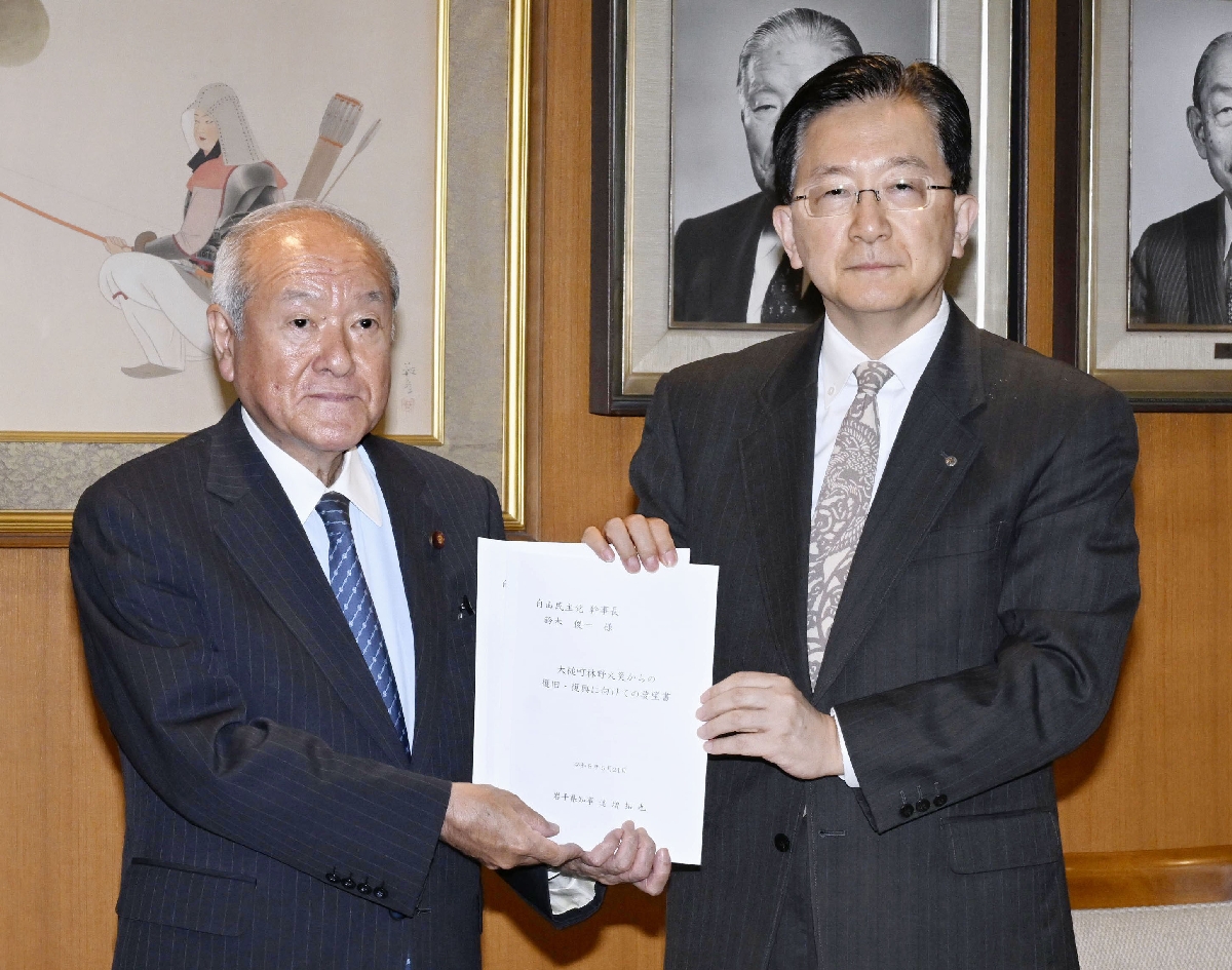 　自民党の鈴木幹事長（左）に要望書を手渡す岩手県の達増拓也知事＝２１日午後、東京・永田町の党本部