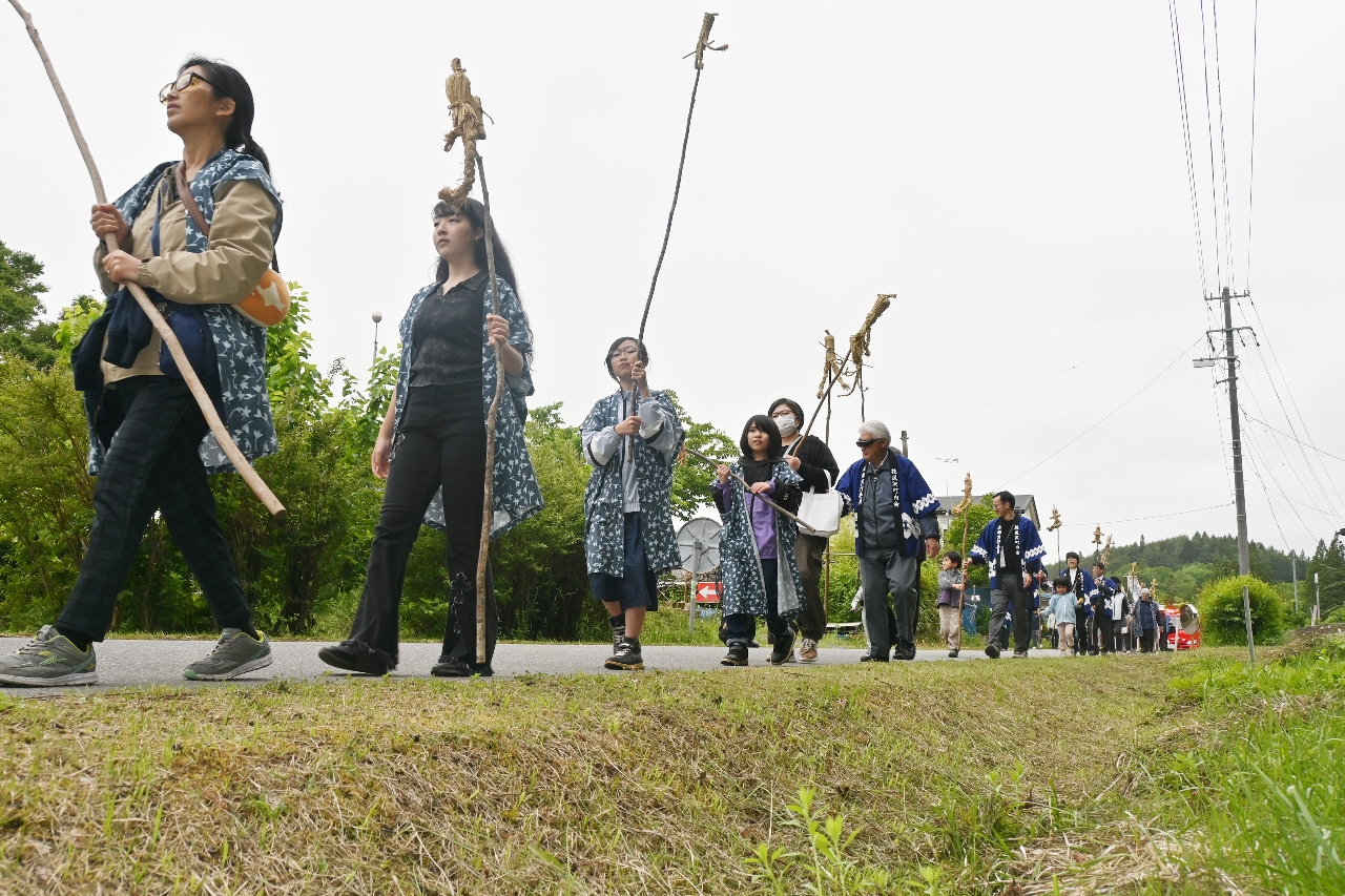 住民がわら人形をくくりつけた棒を手に地区内を練り歩いた「虫まつり」