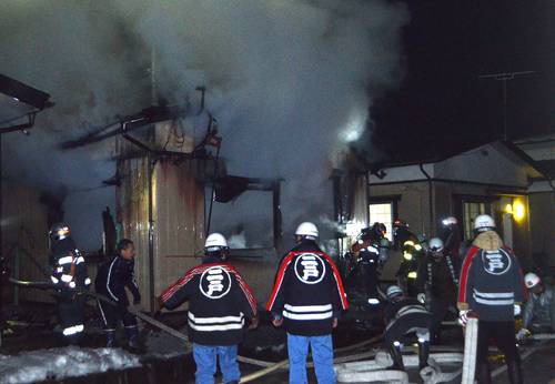 左側の住宅を全焼した火災現場=8日午後9時25分ごろ、二戸市福岡八幡平