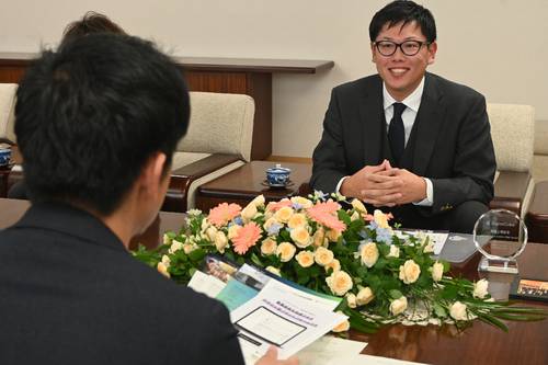 宮下宗一郎知事(左手前)に親会社との上場を報告する立花拓也代表=27日、青森県庁