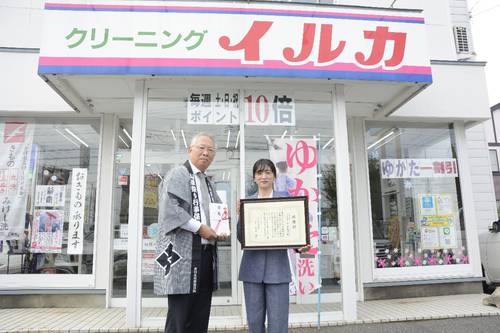 小笠原修会長(左)に目録を手渡した平山佳子代表