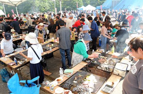 家族連れがバーベキューを楽しむまつり会場