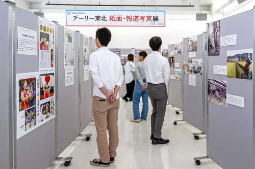 創刊80周年を記念し、主要なニュースを取り上げた紙面と報道写真を展示している会場=15日、八戸市のデーリー東北ホール