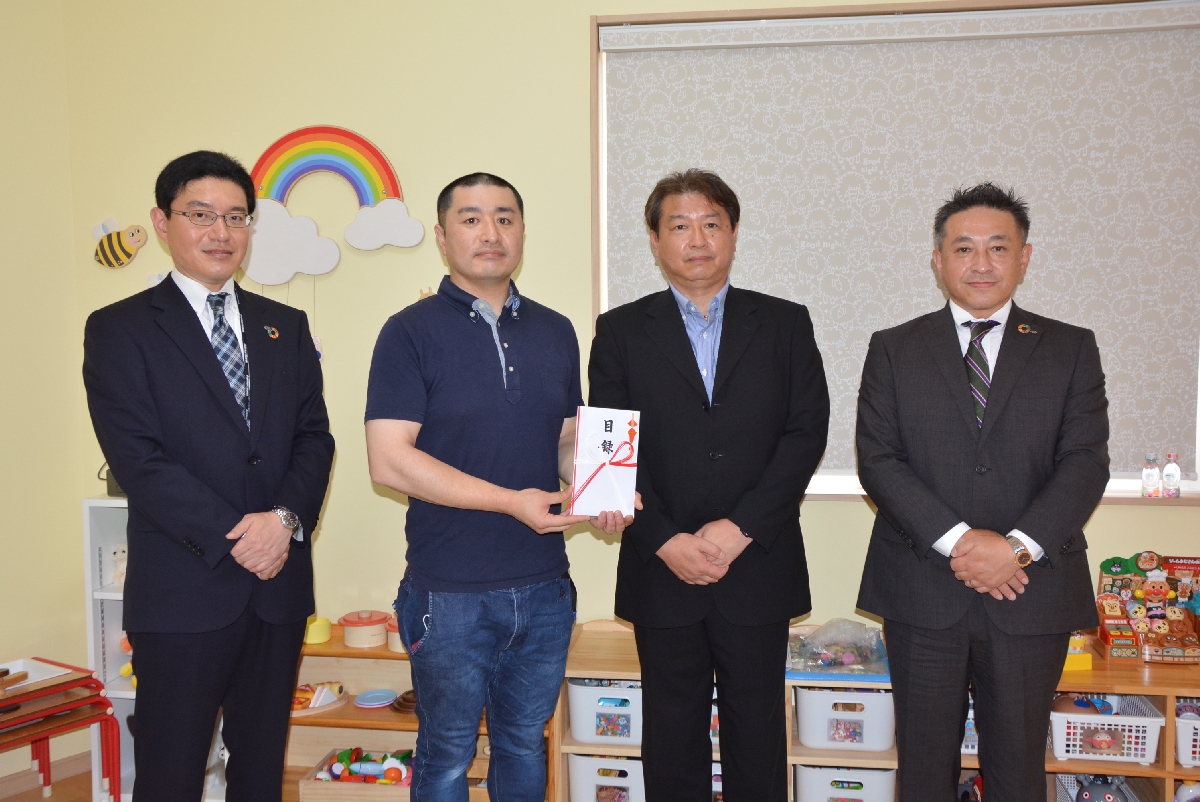 千葉倫明社長(左から3人目)らから目録を受けた青山一航園長(同2人目)